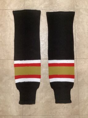 A pair of 32” Black, Gold and Red Hockey Socks. In very good condition.